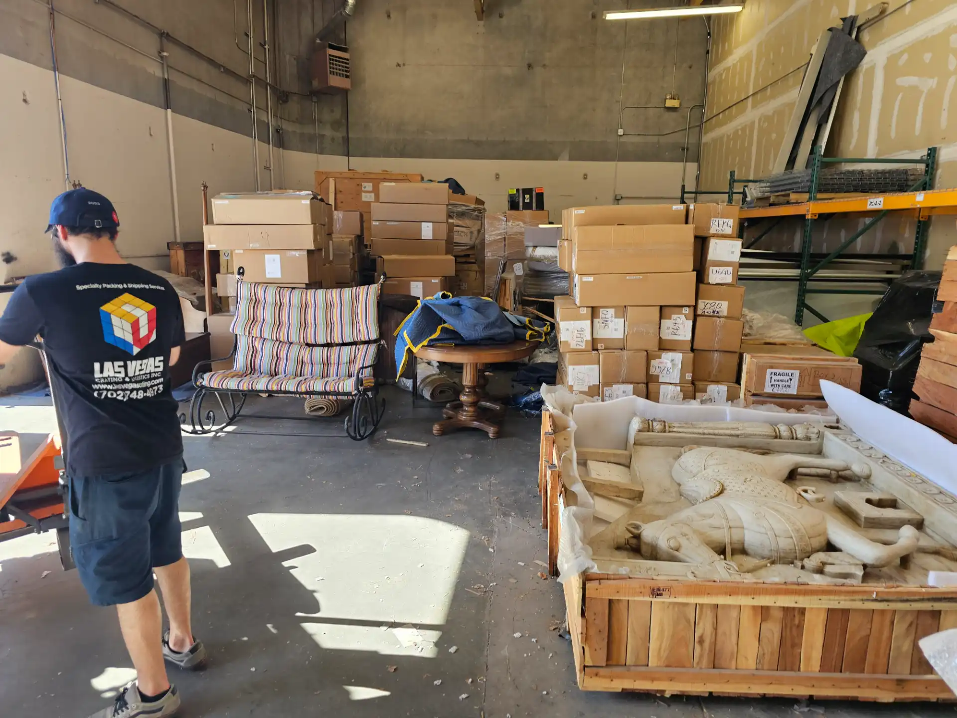 Furniture and crated marble statue staged in the warehouse
